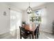 Cozy dining room featuring wood table, seating for six, and a view of the lake at 5460 Sandy Shell Dr, Apollo Beach, FL 33572
