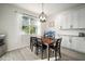 Bright dining room featuring a wood table, seating for six, and a large window at 5460 Sandy Shell Dr, Apollo Beach, FL 33572