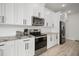 Modern kitchen features white cabinets, stainless steel appliances, and light countertops at 5460 Sandy Shell Dr, Apollo Beach, FL 33572