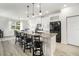 Stylish kitchen features white cabinetry, granite countertops, stainless steel appliances, and island seating at 5460 Sandy Shell Dr, Apollo Beach, FL 33572