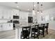 Kitchen with white cabinets, stainless steel appliances, a large island and barstool seating at 5460 Sandy Shell Dr, Apollo Beach, FL 33572