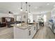 Kitchen island featuring a sink, granite countertop, and barstool seating at 5460 Sandy Shell Dr, Apollo Beach, FL 33572