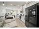 Contemporary kitchen with white cabinets, granite countertops, stainless steel appliances, and a large island at 5460 Sandy Shell Dr, Apollo Beach, FL 33572
