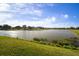 Panoramic lake view surrounded by well-maintained lawns and residential properties under a bright sky at 5460 Sandy Shell Dr, Apollo Beach, FL 33572