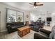 Comfortable living room showcasing sofas, wood coffee table, and open floorplan to kitchen at 5460 Sandy Shell Dr, Apollo Beach, FL 33572
