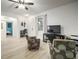 Bright living room featuring wood floors, a ceiling fan, and a television at 5460 Sandy Shell Dr, Apollo Beach, FL 33572