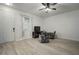 Living room showcasing a white door, window with blinds, ceiling fan, and seating at 5460 Sandy Shell Dr, Apollo Beach, FL 33572
