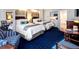 Bright hotel bedroom featuring two beds, blue patterned carpet, and a kitchenette area at 5500 Gulf Blvd # 4228, St Pete Beach, FL 33706