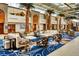 Grand lobby featuring soaring ceilings, palm trees, elegant seating, and a striking blue patterned carpet at 5500 Gulf Blvd # 4228, St Pete Beach, FL 33706