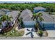 Charming single-story home with a two-car garage, palm trees, and well-maintained landscaping at 606 Winterside Dr, Apollo Beach, FL 33572