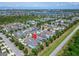 An aerial view of a residential area featuring well-maintained homes and green spaces near a body of water at 606 Winterside Dr, Apollo Beach, FL 33572