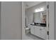 Bathroom with a black granite countertop vanity, a toilet, and glass-enclosed shower at 606 Winterside Dr, Apollo Beach, FL 33572