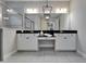 Contemporary bathroom featuring double sinks, sleek fixtures, and a separate walk-in shower at 606 Winterside Dr, Apollo Beach, FL 33572