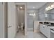 Bright bathroom features a walk-in shower with glass door, sleek vanity, and tile flooring at 606 Winterside Dr, Apollo Beach, FL 33572