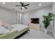 Well-lit bedroom with modern furnishings, a ceiling fan, and access to a walk-in closet at 606 Winterside Dr, Apollo Beach, FL 33572
