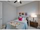 Cozy bedroom with a ceiling fan, accent art, and a stylish nightstand with lamp at 606 Winterside Dr, Apollo Beach, FL 33572