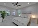 Bright bedroom featuring windows, a ceiling fan, neutral decor and a comfortable bed at 606 Winterside Dr, Apollo Beach, FL 33572