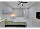 Light and airy bedroom with neutral decor, ceiling fan, and ensuite bath for added convenience at 606 Winterside Dr, Apollo Beach, FL 33572