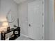 Inviting entrance hall features a decorative table, lamp, and a round mirror at 606 Winterside Dr, Apollo Beach, FL 33572