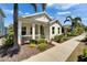 Charming single-story home with a welcoming front porch and lush, tropical landscaping at 606 Winterside Dr, Apollo Beach, FL 33572