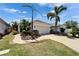 The property features a well-maintained lawn, an attached two-car garage, and lush tropical landscaping at 606 Winterside Dr, Apollo Beach, FL 33572