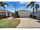 Charming single-Gathering home boasts a well-manicured lawn, lush landscaping, and a spacious two-car garage at 606 Winterside Dr, Apollo Beach, FL 33572