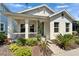 Inviting single-story home with a cozy front porch and lush, meticulously maintained landscaping at 606 Winterside Dr, Apollo Beach, FL 33572
