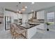 Modern kitchen with stainless steel appliances, a large island, and sleek countertops at 606 Winterside Dr, Apollo Beach, FL 33572