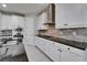 Modern kitchen showcasing white cabinets, granite countertops, stainless steel appliances, and backsplash at 606 Winterside Dr, Apollo Beach, FL 33572