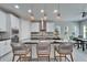 Bright kitchen boasts granite counters, white cabinets, stainless appliances, and pendant lighting at 606 Winterside Dr, Apollo Beach, FL 33572