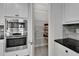 The kitchen features stainless appliances, granite counters, and a walk-in pantry for storage at 606 Winterside Dr, Apollo Beach, FL 33572