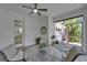 Screened-in patio offers a relaxing outdoor space with a ceiling fan and comfortable seating area at 606 Winterside Dr, Apollo Beach, FL 33572