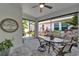 Enclosed patio featuring a round table with seating and views of the lush garden at 606 Winterside Dr, Apollo Beach, FL 33572