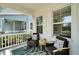 A welcoming covered porch with outdoor seating provides the perfect spot to relax and enjoy the neighborhood views at 606 Winterside Dr, Apollo Beach, FL 33572