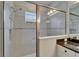 Modern shower with glass enclosure, rainfall showerhead, mosaic tile accents, and window at 606 Winterside Dr, Apollo Beach, FL 33572