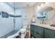 Well-lit bathroom with a glass shower, modern vanity, and stylish round mirror at 6141 Bahia Del Mar Blvd # 129, St Petersburg, FL 33715