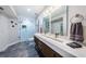 Modern bathroom featuring a glass shower and a double sink vanity with sleek fixtures at 6141 Bahia Del Mar Blvd # 129, St Petersburg, FL 33715
