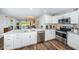 Updated kitchen with stainless steel appliances, white cabinets, and open layout to living spaces at 6141 Bahia Del Mar Blvd # 129, St Petersburg, FL 33715