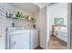 Convenient laundry room area with a washer and dryer, plus storage shelving at 6141 Bahia Del Mar Blvd # 129, St Petersburg, FL 33715