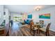Bright living room with modern decor, sleek flooring, and a view to dining area at 6141 Bahia Del Mar Blvd # 129, St Petersburg, FL 33715