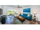 Bright living room with a blue sofa, wood floors, and sliding doors to the outside at 6141 Bahia Del Mar Blvd # 129, St Petersburg, FL 33715