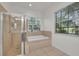 The bathroom features a walk in shower and tub at 6205 Ibispark Dr, Lithia, FL 33547