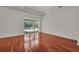Sun-filled bedroom with hardwood floors and sliders to the outdoor living area at 6205 Ibispark Dr, Lithia, FL 33547
