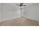Cozy bedroom featuring neutral carpet, ceiling fan, and a window at 6205 Ibispark Dr, Lithia, FL 33547