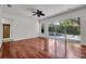 This bedroom offers wood floors and large windows overlooking the pool and landscaping at 6205 Ibispark Dr, Lithia, FL 33547