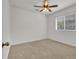 Cozy bedroom with neutral carpet, natural light from windows, and ceiling fan at 6205 Ibispark Dr, Lithia, FL 33547