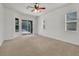 A neutral bedroom has ample light and carpet at 6205 Ibispark Dr, Lithia, FL 33547