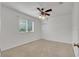 Clean bedroom featuring ceiling fan and large window for great natural light and neutral carpeting at 6205 Ibispark Dr, Lithia, FL 33547
