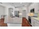 The open kitchen features granite counters, stainless appliances and warm wood flooring at 6205 Ibispark Dr, Lithia, FL 33547