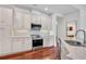 Well-equipped kitchen features stainless appliances, granite countertops and white cabinetry at 6205 Ibispark Dr, Lithia, FL 33547